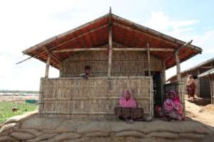 Women sitting outside their new shelter
