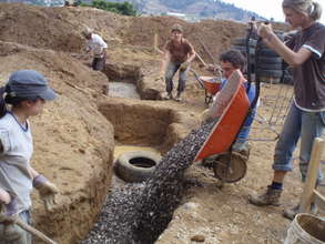 LWH volunteers filling in the foundation with rock