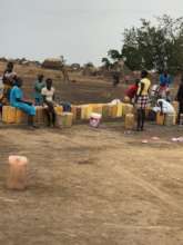 Women line up at the well with jerry cans