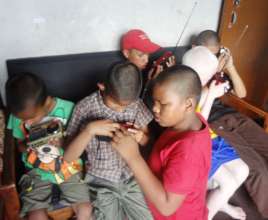 Children concentrating in tuning radio