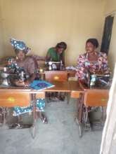 Graduates sewing in their own joint tailoring shop