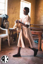 Young student at Soko receiving new school shoes