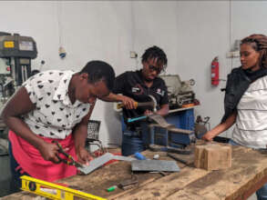Girls modifying their prototypes in the Makerspace