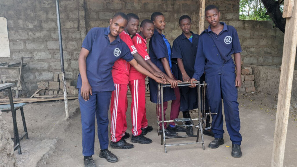 Orkolili students posing with their maize planter