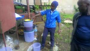Form 4 student sharing his water filter prototype
