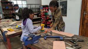 Build-It students making a mini wardrobe