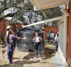 Students explain the rainwater system to visitors