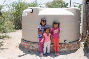 Girls with their new rainwater system in Los Ricos