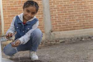 A young girl opens her new rainwater system