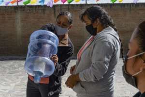 Women inspecting a new ceramic water filter