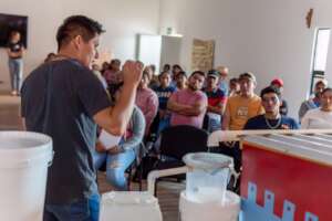 Caminos staff teaching a rainwater workshop