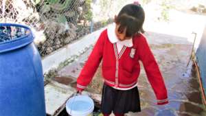 Carrying rainwater to filter in La Vaciada