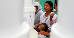A mother and her child in a water filter workshop