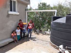 A family shows off their new rainwater system