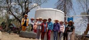 Partners from CUVAPAS at a system they built