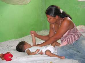 Mother giving exercises to son with Cerebral Palsy