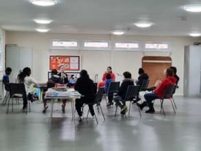 Children doing circle time at the club for social