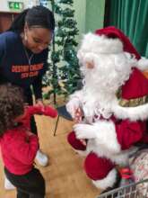 Santa giving Christmas gifts to each child
