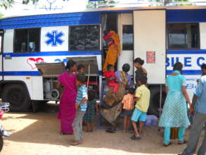 Women and children attending mobile clinic  India