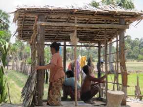 Villagers Building The Walls/Ceiling Of A Latrine