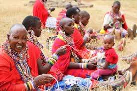 women making beads in an open air place