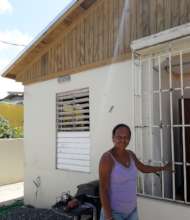 Brenda in Front of Her Newly Roofed Home