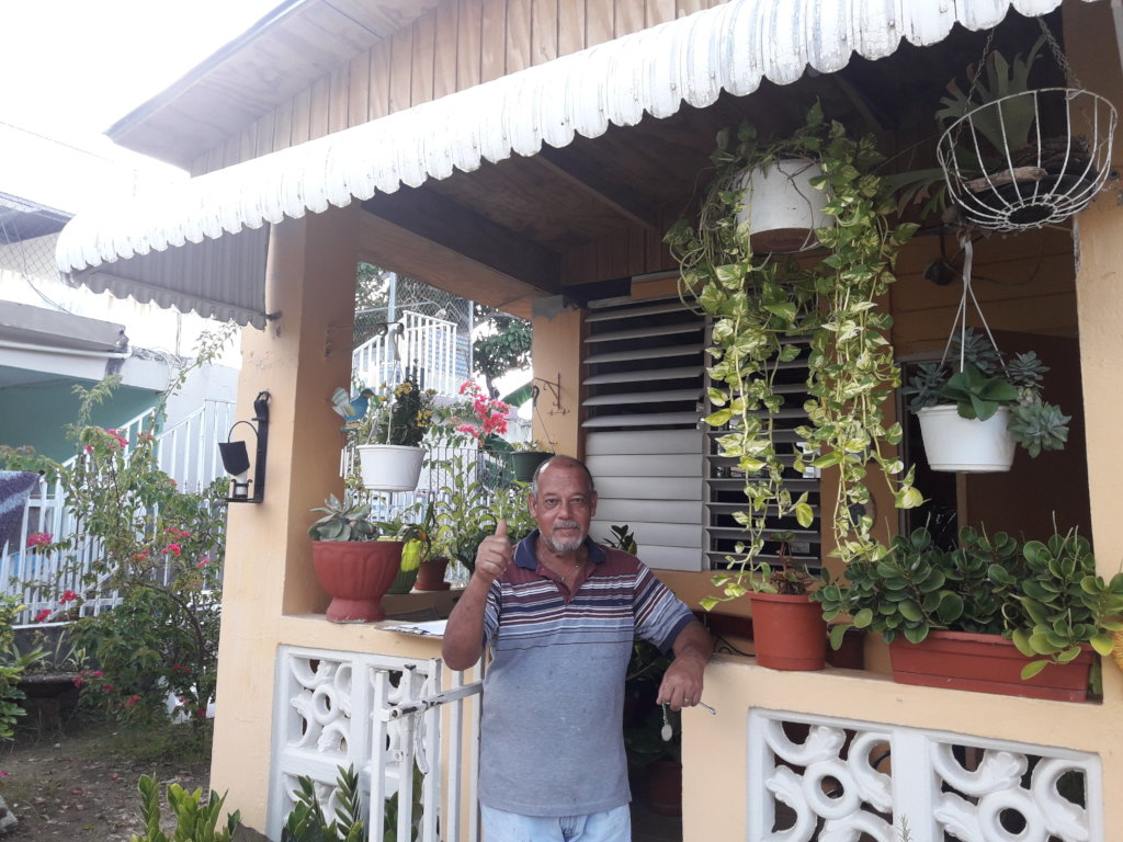 Jose in Front of His Newly Roofed Home