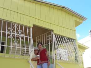 Nilda in front of her newly built roof