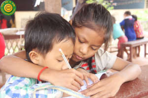 Helping a boy to write.