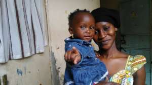 Awa and daughter help make purses.