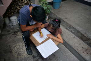 Israel helping Damaris with her work