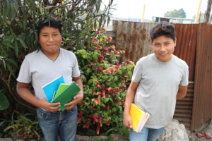 Diego and David showing off new school supplies