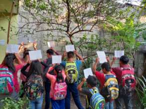 Students and their new backpacks with "THANK YOU"