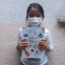 Damariz reads her book at home