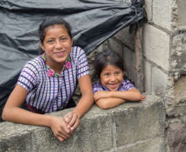 Dolores stands next to her older sister Pascuala