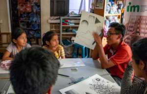 Jose Miguel shows his work to the class