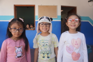 Students proudly wearing their new glasses