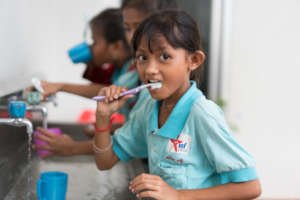 Students brushing their teeth after lunch at ISF