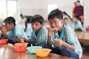 Students enjoying a nutritious meal at ISF