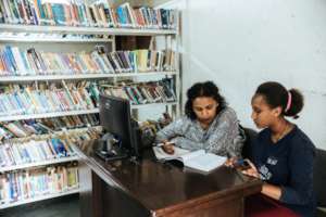 Asnaku tutoring Sinafikish with her studies