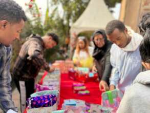 Staff giving out gifts for the kids achievement