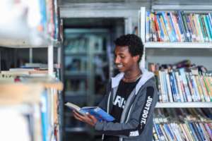 Youth accessing BHE's library with  >13,000 books