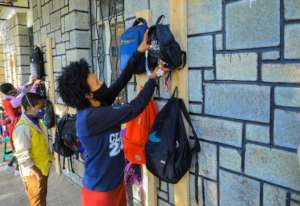 Students hanging bags individually to keep hygiene