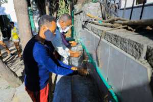 Students wash hands with distanced water taps