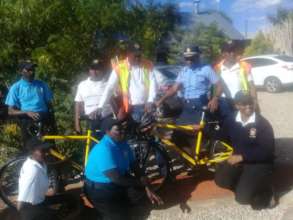 Neighbourhood watch volunteers receiving bicycles