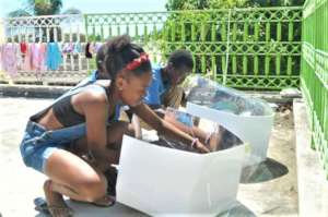 Girl & boy learn solar cooking