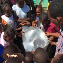 Hinche - Kids surround solar cooking demo