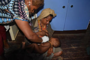 Lucy examines a baby at the IHS Health Center