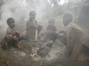 Children inhaling smoke from an open fire