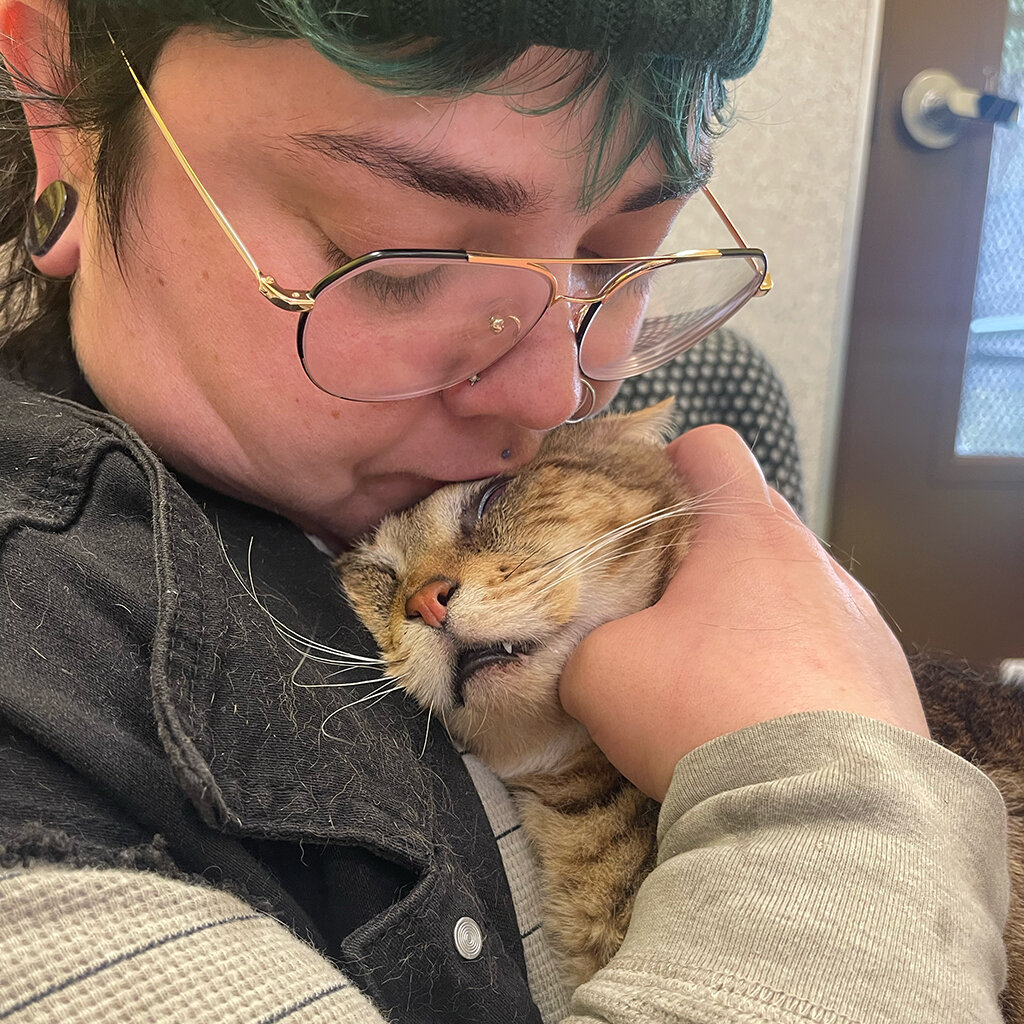 Coolie snuggles with his new person.